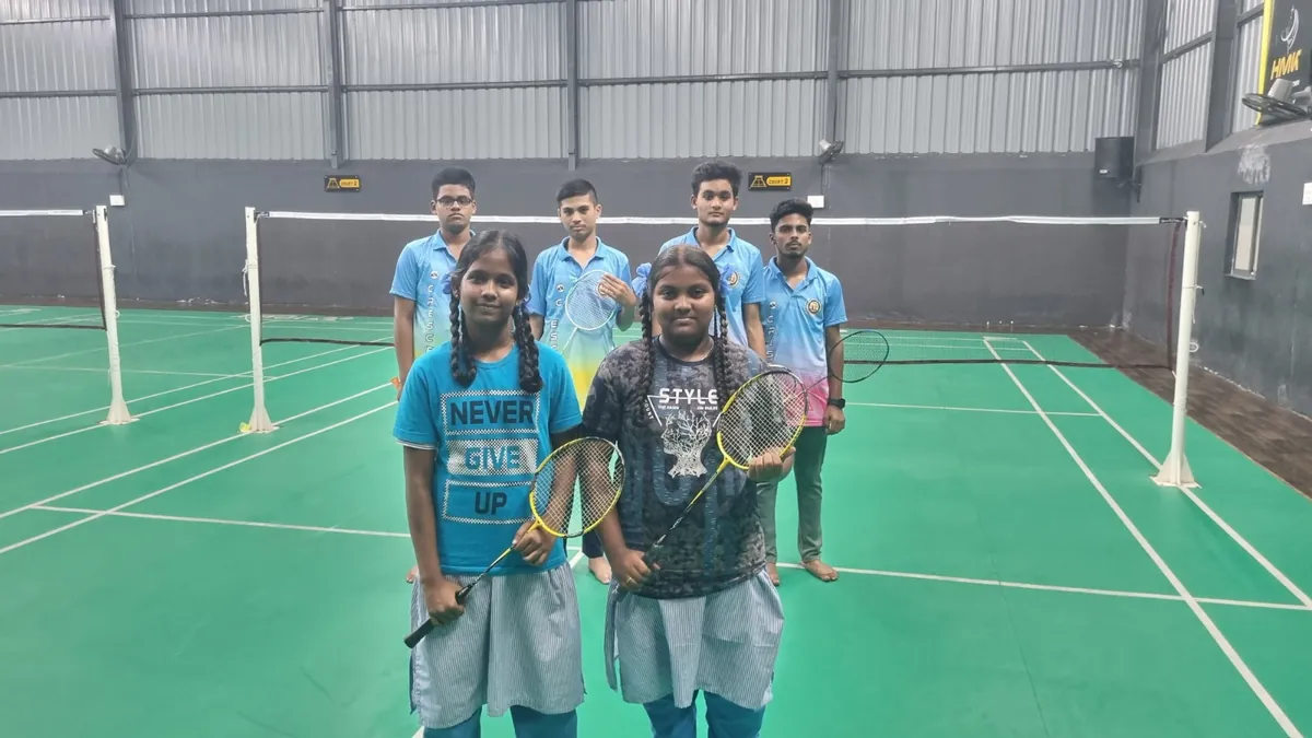 Students with their rackets on the school badminton court