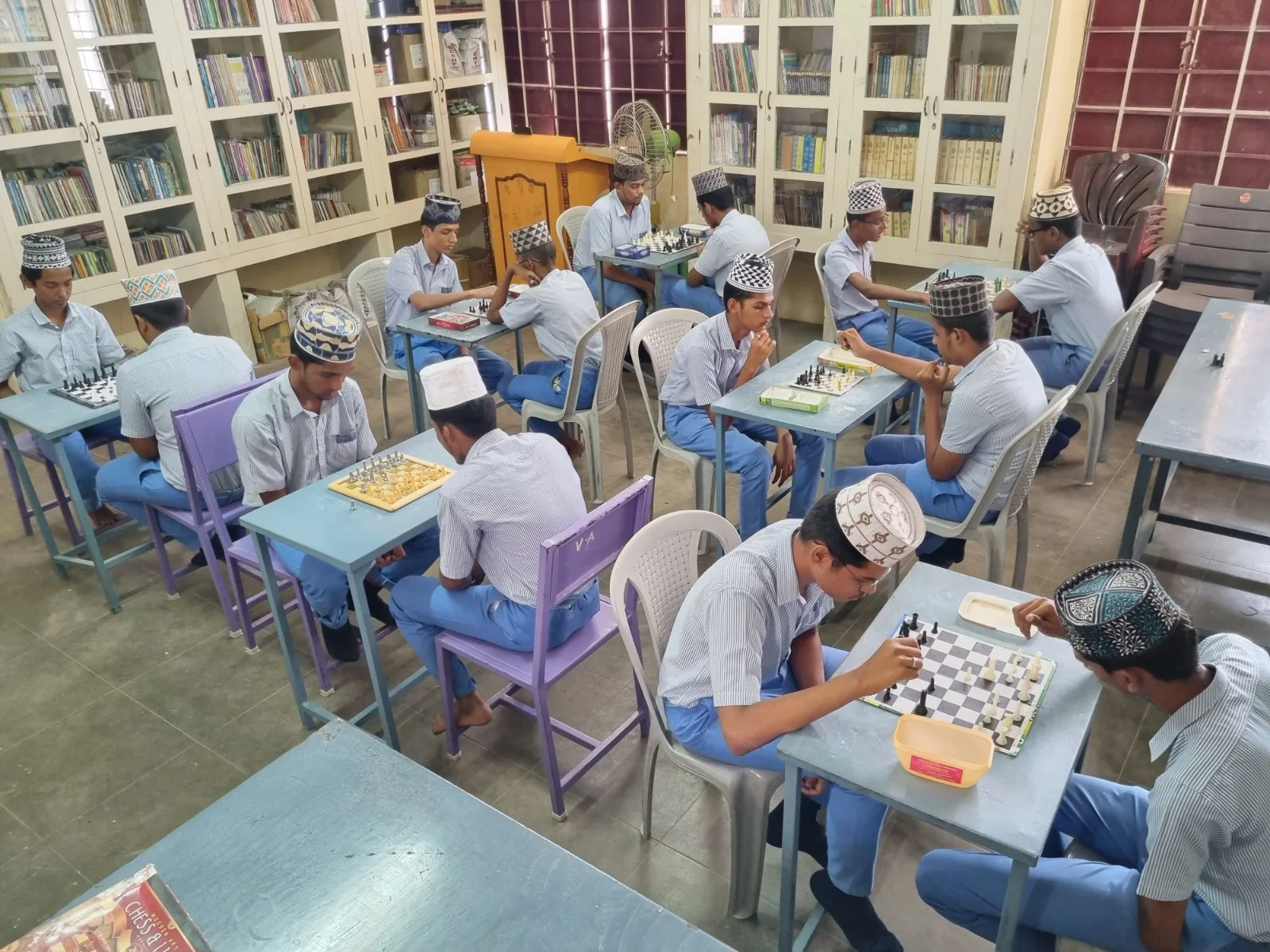 Students playing chess in the school library